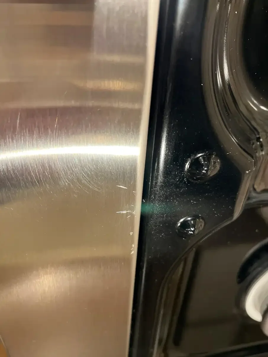 Scuffed stainless cooktop before repair