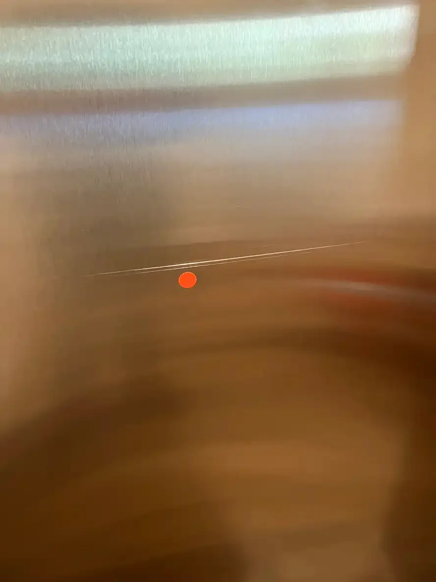 Scratched stainless elevator door before repair